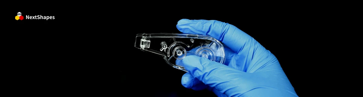Close-up of a 3D printed transparent component held in a blue nitrile glove, made with NextShapes 8001 transparent resin (90.8% light transmittance), showcasing crystal clarity, zero impurities, and bubble-free finish