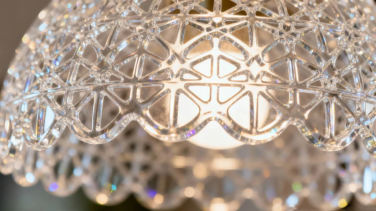 Lit effect display of 3D printed artistic lace lampshade made with NextShapes Precision Clear, highlighting crystal clarity, uniform light diffusion, and complex hollow structure stability