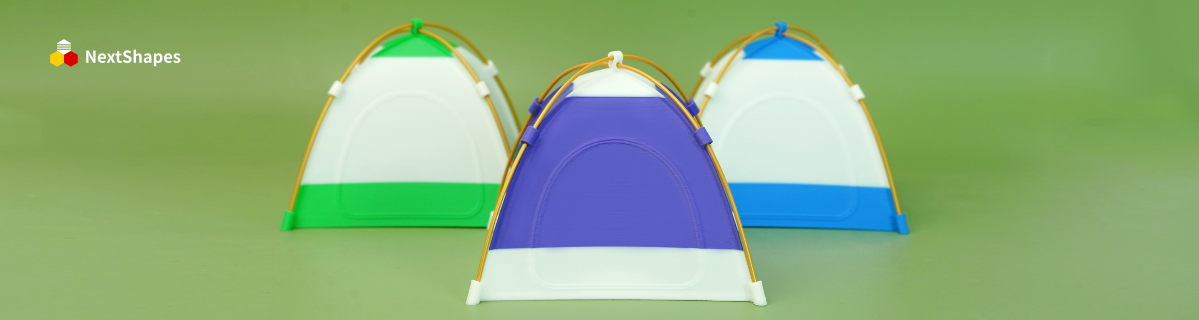 Three colorful tent-shaped lamps 3D printed with NextShapes Standard PLA filament, showcasing smooth surfaces and vibrant colors against a light green background.