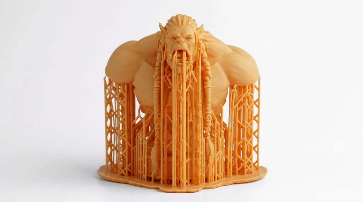 Display of 3D printed figure model with support structures made with NextShapes Hight Resolution 12K Red Wax Resin, demonstrating strong overhang performance and easy support removal