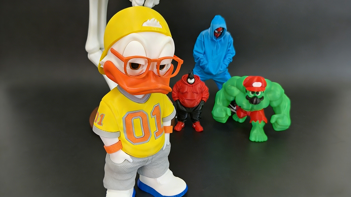 Collection of 3D printed collectible figures made with NextShapes PETG HF filament, including a yellow duck character, hooded spider figure, and green hulk-style toy, highlighting the material's detail and toughness