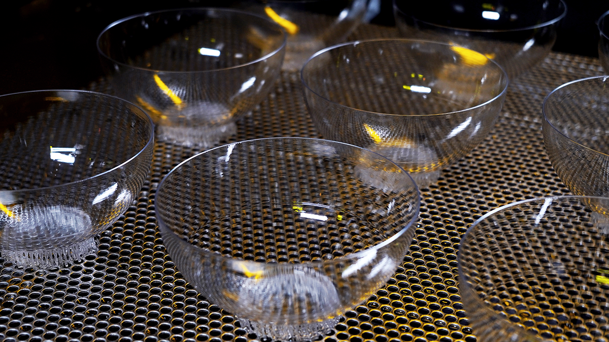 Multiple transparent bowl-shaped components 3D printed with Precision Clear resin on an SLA 3D printer, highlighting consistent clarity and easy cleaning for industrial applications.